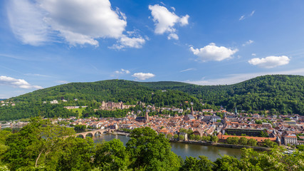 Fototapeta na wymiar Heidelberg in Summer with a view on the castle, the Church of the Holy Spirit (Heiliggeistkirche) and the old bridge, shot from Philosophenweg.