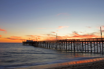 Beach pier at sunset in California