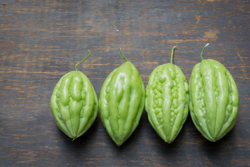 Bitter gourds isolated on wood background .