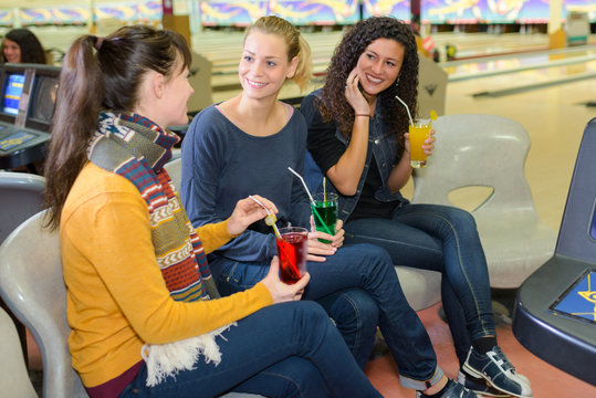 Women with refreshments at bowling alley