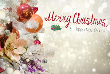 Fototapeta na wymiar christmas white tree with holiday red and orange decorations and lights with copy space on silver bokeh background with merry christmas greetings
