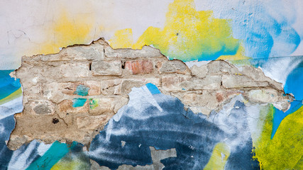 dilapidated brick wall with traces of graffiti