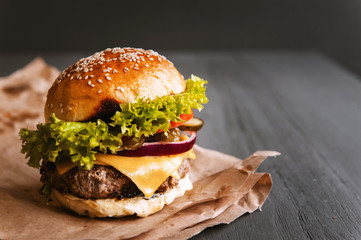 Delicious fresh homemade burger on a wooden table