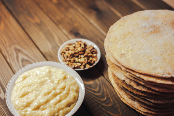 ingredients for baking homemade cake. shortcakes, buttercream or cream and nuts 