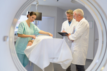 View of patient and medical staff from inside scanning tunnel
