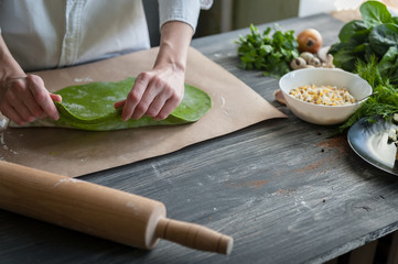 chef rolls the dough for ravioli
