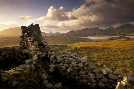 Old blackhouse ruin near Timsgarry (Timsgearraidh), west coast, sunset. Isle of Lewis, Outer Hebrides, Scotland