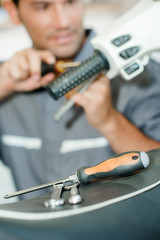 Mechanic working on handlebars of scooter