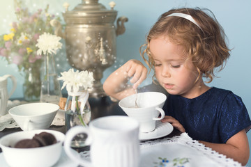 Magical tea party with little curly girl
