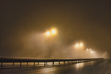Street lights, foggy night, lamp post lanterns, deserted road in mist fog, wet asphalt and tram