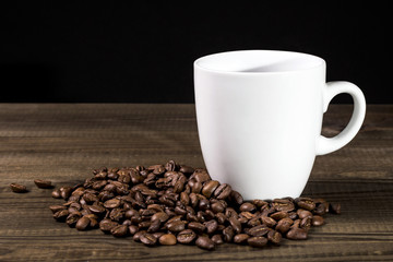 Coffe cup with coffee beans on wooden table. image with copy space