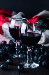 two glasses of red wine, grapes