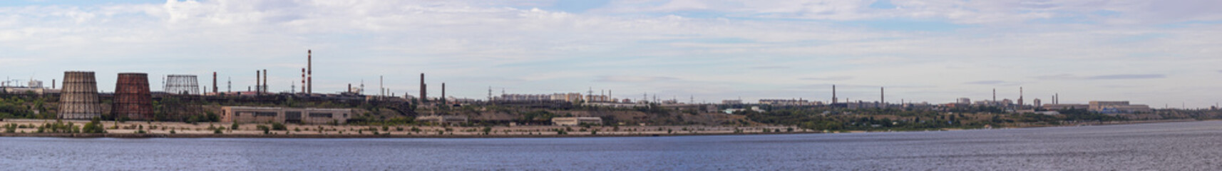 Fototapeta na wymiar Panoramic view of ironworks on river coastline