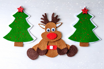 greeting card handmade christmas reindeer from felt on white wooden background