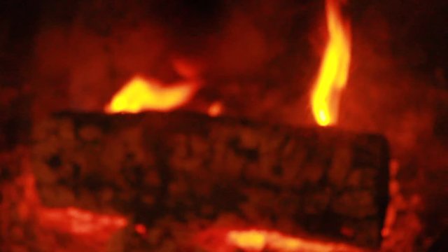 Beech Log burning - slow flames - close-up - blurring out fast