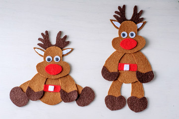 greeting card handmade christmas reindeer from felt on white wooden background