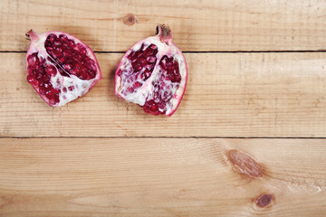 Parts of pomegranate on wooden table
