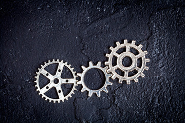 concept hour metal gears on dark background top view