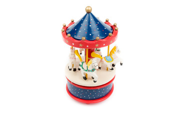 Musical carousel with horses. Blue, red merry go round. Toy. Vintage carousel, made from solid wood. Winter, Christmas, New Year decoration. Isolated on white background. Closeup. Top, side view.