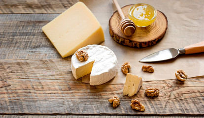 red wine with cheese and honey on wooden background