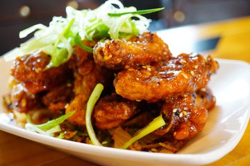 Platter of Korean barbecue chicken wings with scallions