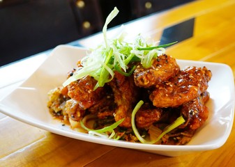 Platter of Korean barbecue chicken wings with scallions