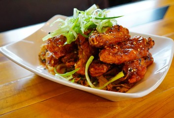 Platter of Korean barbecue chicken wings with scallions
