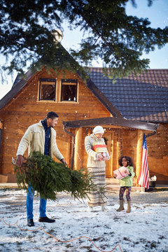 Happy Family Preparing Mountain House For Christmas