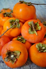 Pile of ripe orange persimmon fruit