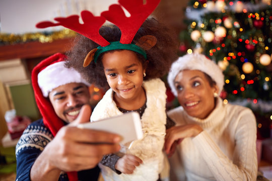 Happy family taking selfie during Christmas.