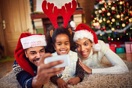 Black family taking Christmas selfie together