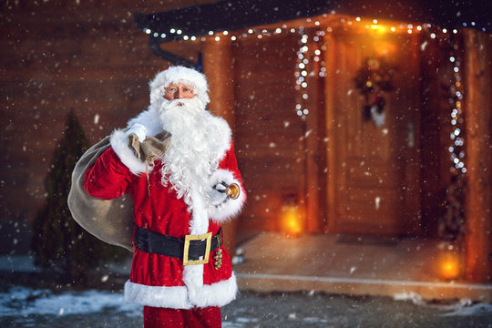 Santa Claus with bell and sack of presents