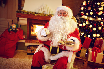 Santa Claus served with delicious cookies - obrazy, fototapety, plakaty