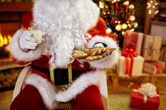 Christmas, holidays, food, drink and people concept - of Santa C