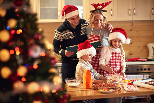 children and parents preparing cookies for Xmas.