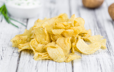 Potato Chips (Sour Cream taste) on vintage wooden background