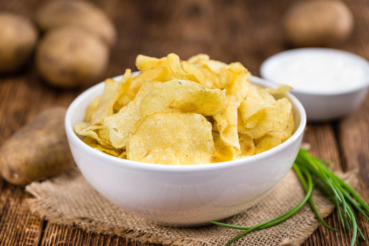 Potato Chips (Sour Cream taste) on vintage wooden background