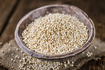Portion of puffed Quinoa (selective focus) on an old wooden tabl