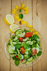 Diet plan, menu or program, tape measure and diet food of fresh vegetable salad, lemon on wood background, weight loss and detox concept, top view