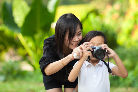 Mother and Daughter taking pictures at the nature field.