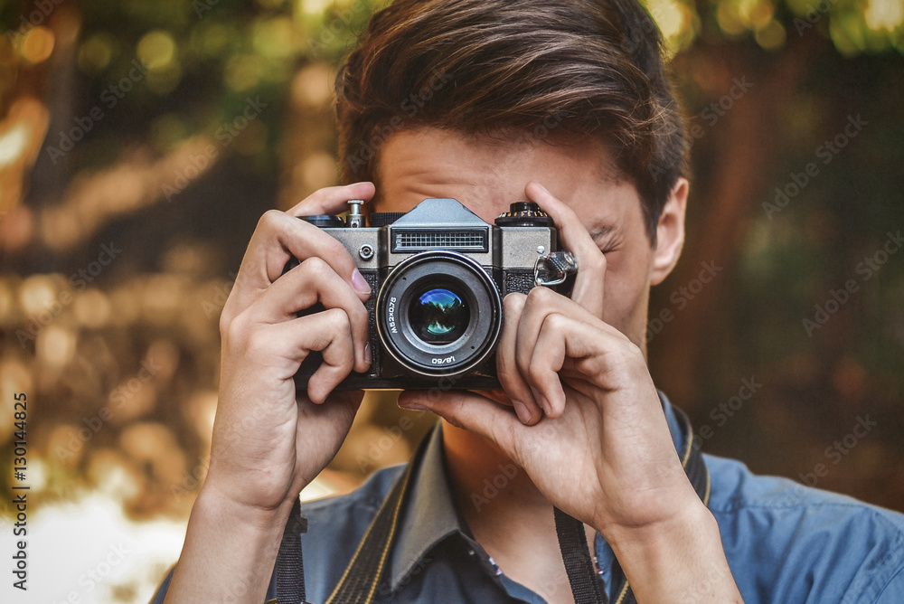 Wall mural hipster photographer with retro camera