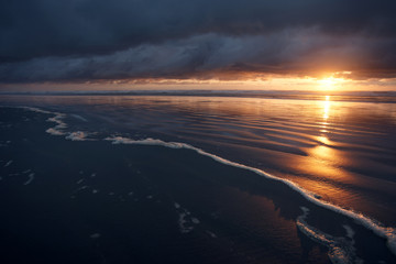 Fototapeta na wymiar Ocean sunset seascape at the ocean on a stormy evening
