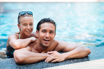 Passionate young couple in swimming pool