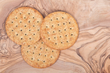 Wheat crackers on olive wood cutting board 