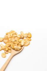 Broad bean in spoon on white background.