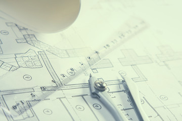 Architectural plans, compass and ruler on the desk
