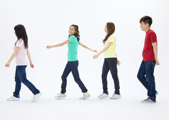 Fototapeta premium Young men and women walking in a row