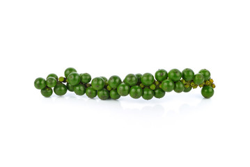 green peppercorns on white background