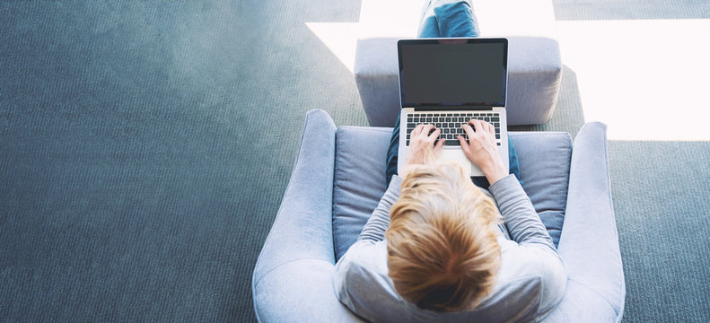 Man On A Laptop In Bright Window Lit Room