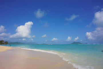 Lanikai beach on the island of Oahu in Hawaii with deep blue sky and light blue ocean